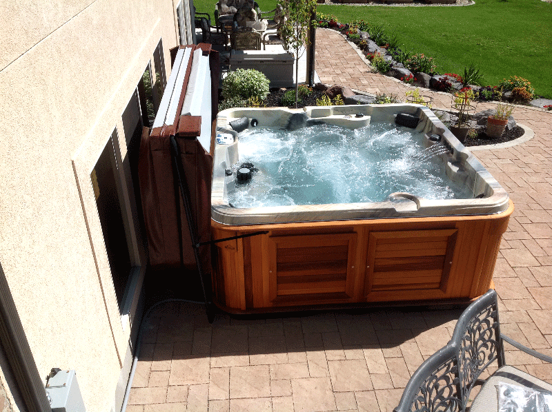 Arctic Spas Hot tub with an open cover in the backyard